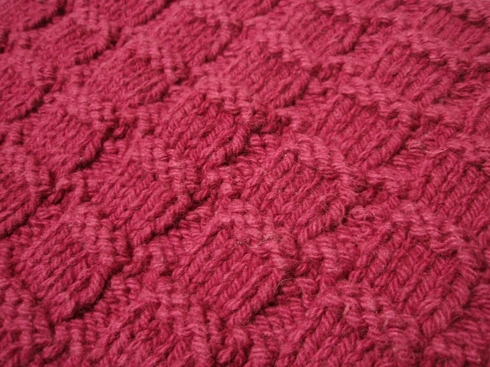 Close-up of stacked knitted fabric showing its texture